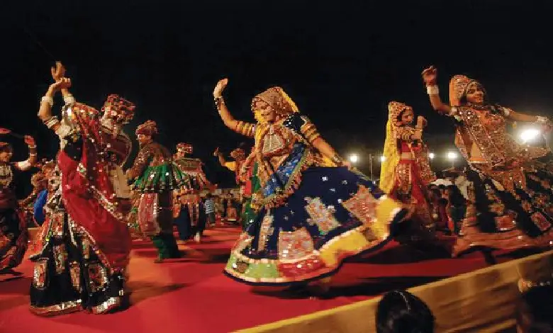 A group of people playing garba, a traditional Gujarati dance