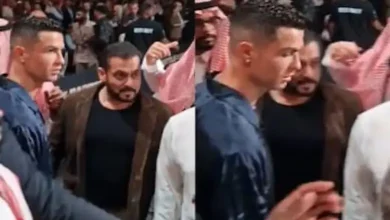 Salman Khan stands in the background as Cristiano Ronaldo hugs others at a boxing match.
