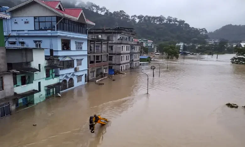 A photo of the Sikkim flash floods, with a caption that says "PM Modi's reaction revealed, search for missing soldiers continues