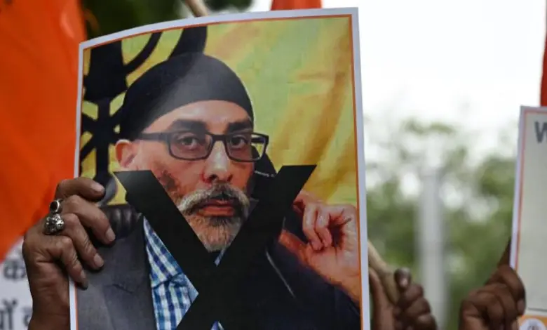 A participant holds a banner depicting Khalistani separatist Gurpatwant Singh Pannun during a rally in New Delhi on September 24, 2023