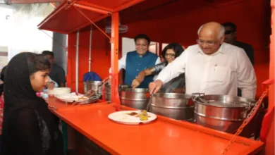 Gujarat Chief Minister Bhupendra Patel serving food to workers at a construction site