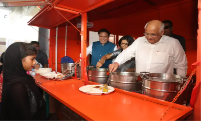 Gujarat Chief Minister Bhupendra Patel serving food to workers at a construction site