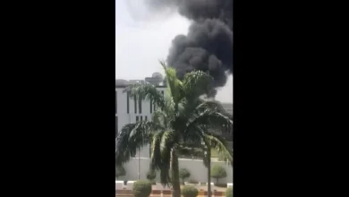 In a screenshot taken from a video, plumes of smoke are shown coming from inside the compound of the High Commission of Canada in Abuja, Nigeria, on Monday