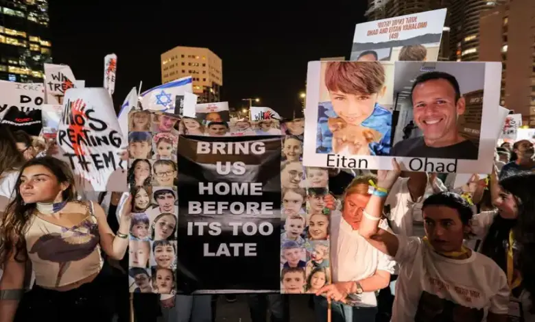 People gather with signs in Tel Aviv on November 9, 2023, to call for the release of Israeli hostages abducted by Hamas.