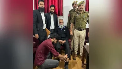 Jammu and Kashmir Police officer attaching a GPS tracker anklet to a terror accused individual on bail
