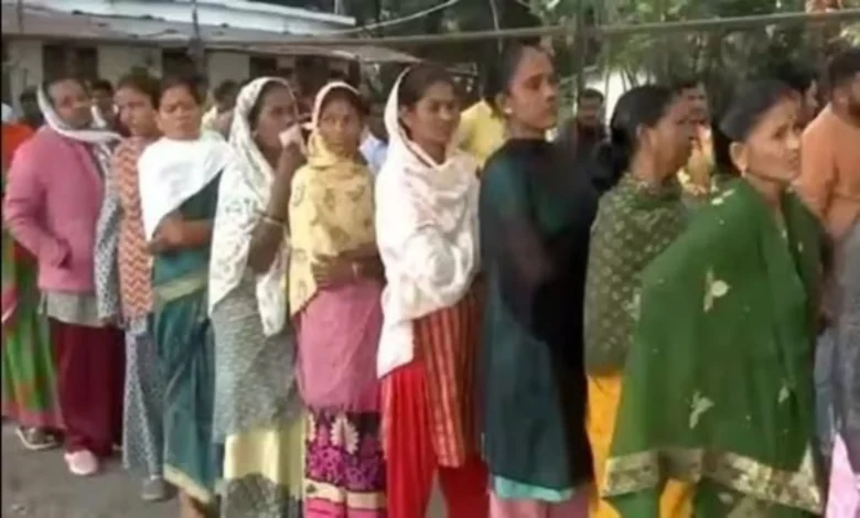 Voters queue up outside a polling booth in Kondagaon in Chhattisgarh as they await their turn to cast a vote in the first phase of assembly elections