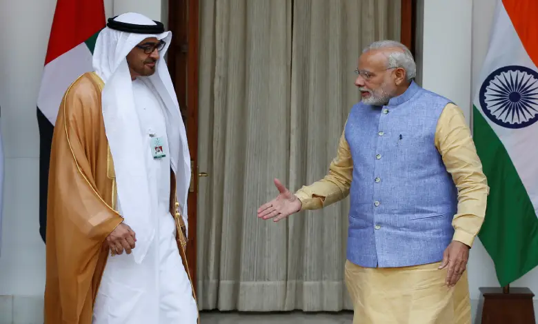 UAE and India flags shaking hands, symbolizing the strong bilateral relationship between the two countries.
