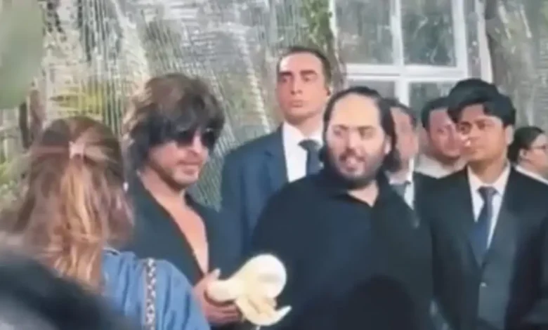 Anant Ambani and Shah Rukh Khan laughing and sharing a lighthearted moment