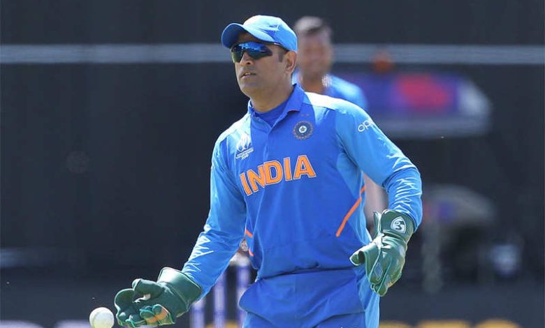 MS Dhoni smiling and waving to fans