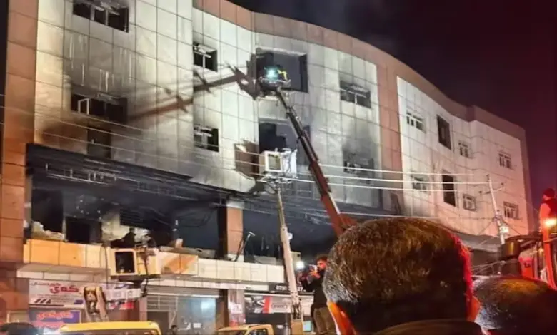 Firefighters undertake a rescue operation after the Soran University fire