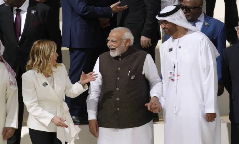 Italy Premier Giorgia Meloni, left; India Prime Minister Narendra Modi, center; and COP28 President Sultan al-Jaber speak at a group photo Friday at the COP28 U.N. Climate Summit in Dubai, United Arab Emirates.