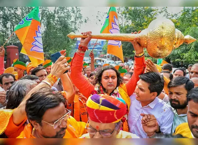 A photo of Balamukundacharya, a BJP MLA from Rajasthan, speaking at a public event.