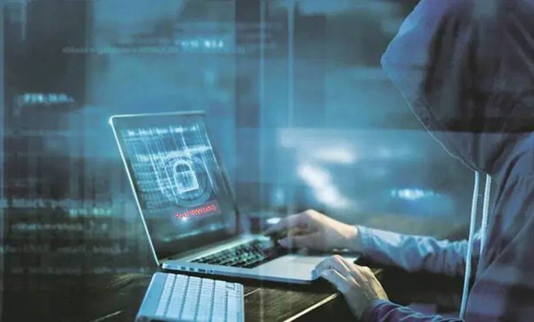 An illustration of a person using a computer with a shield icon representing cyber security.