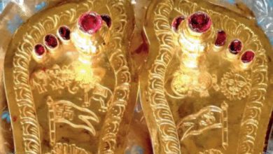 A close-up view of Lord Ramlala's ornate charan paduka, adorned with gold and silver.