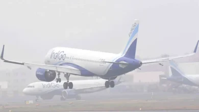 Airplanes grounded at Delhi-Amritsar airport shrouded in thick fog, causing flight delays and disruptions.