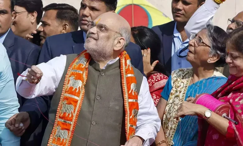 Union Home Minister Amit Shah smiles as he flies a kite amidst jubilant crowd in Ahmedabad during Uttarayan celebrations.