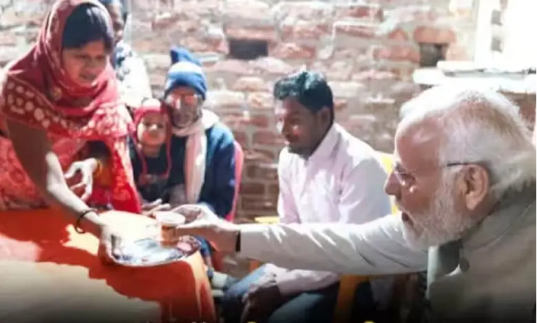 Prime Minister Narendra Modi smiles while receiving a cup of tea from Meera Majhi in Ayodhya
