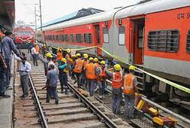 A derailed coach of the Charminar Express lies on its side at the Nampally railway station in Hyderabad, Telangana, India. Rescue workers are seen attending to the injured passengers.