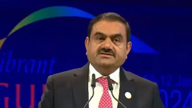 Gautam Adani addressing the Vibrant Gujarat Summit 2024, announcing a 2 lakh crore investment in Gujarat over 5 years in sectors like renewables, infrastructure, and data centers.