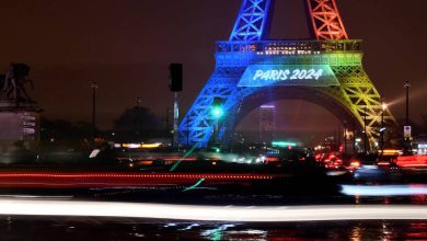 Eiffel Tower in Paris lit in the colors of the Olympic flag