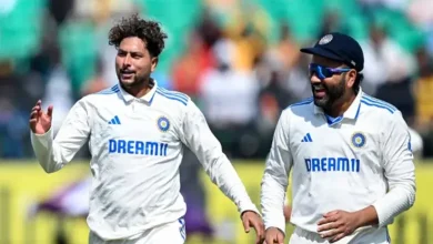 India's Kuldeep Yadav celebrates with his captain Rohit Sharma (R) after taking the wicket of England's captain Ben Stokes