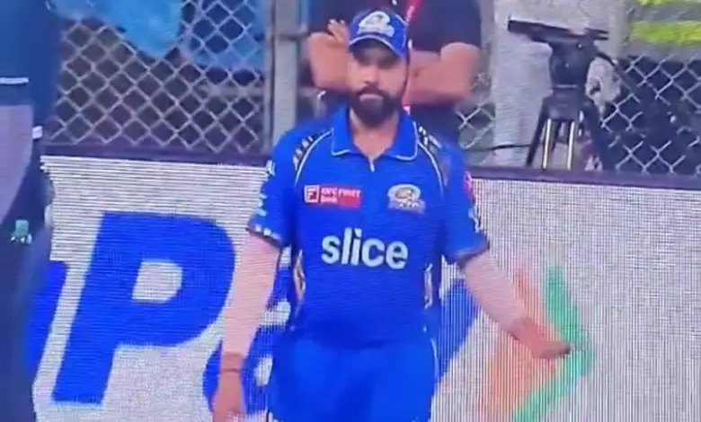 Rohit Sharma gesturing to the crowd for silence