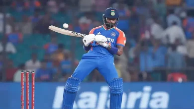 Hardik Pandya holding the bat with which he hit the no-look shot during a cricket match