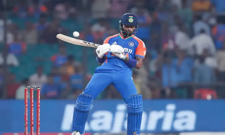 Hardik Pandya holding the bat with which he hit the no-look shot during a cricket match