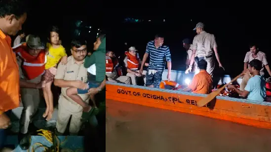 rescue teams evacuating people from flooded bhadrak village