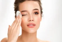 "woman gently removing makeup with a cleansing wipe"