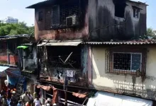 "Aftermath of devastating fire in Mumbai slum, destruction and debris"