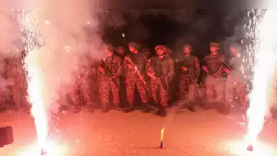 soldier lights lamp to celebrate diwali