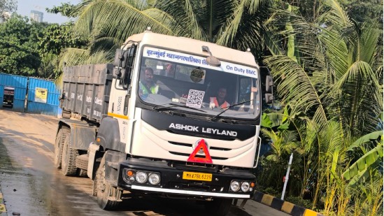 "BMC workers collecting debris as part of free pickup service in Mumbai"