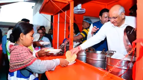 Workers enjoying a meal provided under a government scheme for five rupees