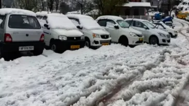 Snow falls on vehicles in Mount Abu