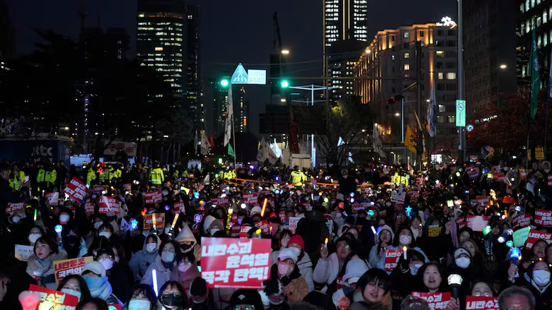 A large crowd gathers in Seoul on Tuesday ahead of a rally aimed at demanding the impeachment of South Korean President Yoon Suk Yeol in the wake of his recent — and ultimately failed — bid to impose martial law.