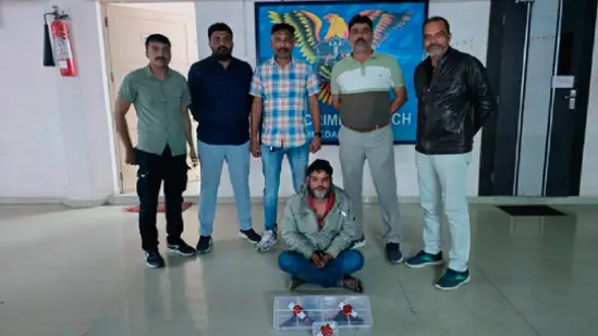 SOG Ahmedabad team with seized pistols and cartridges