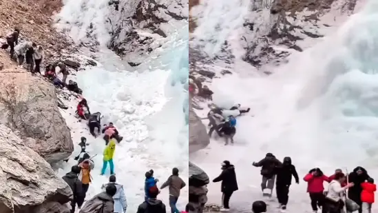 People enjoying under a frozen waterfall in China