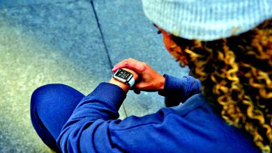 Young people using smartwatches during outdoor activities