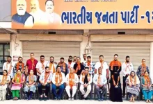 BJP leaders celebrating victory with placards after winning 215 uncontested seats in local body elections.