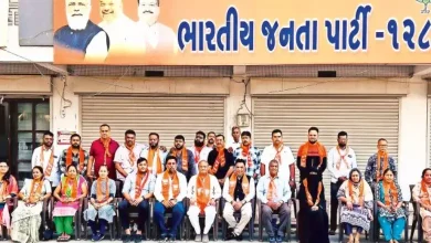 BJP leaders celebrating victory with placards after winning 215 uncontested seats in local body elections.