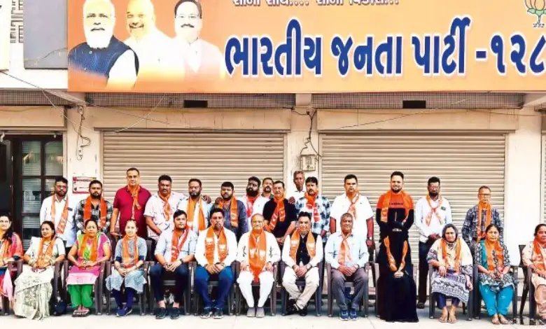 BJP leaders celebrating victory with placards after winning 215 uncontested seats in local body elections.