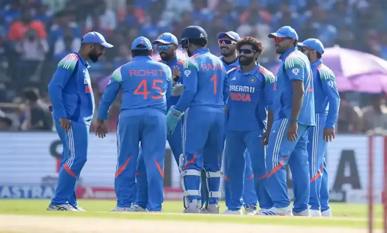 Jasprit Bumrah and Varun Chakravarthy in cricket jerseys during Champions Trophy match.