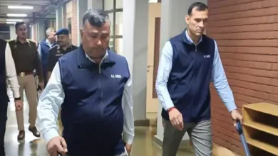 Security personnel inspecting a school in Delhi after a bomb blast threat.