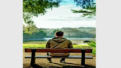 Person meditating peacefully in a natural setting, symbolizing slow living philosophy.