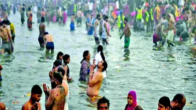 A person performing a spiritual bathing ritual near a river, symbolizing purity and devotion.