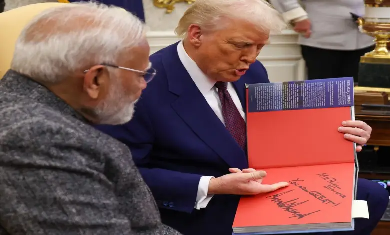 "Trump handing a special gift to Modi with a note saying 'Mr Prime Minister, you are great' at a public event."