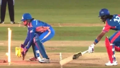 LED stumps light up during WPL match as umpire reviews run-out decision between Delhi Capitals and Mumbai Indians.