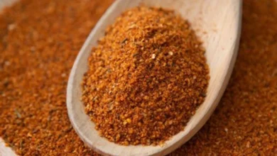 Person adding Buknu spice to food for digestive health