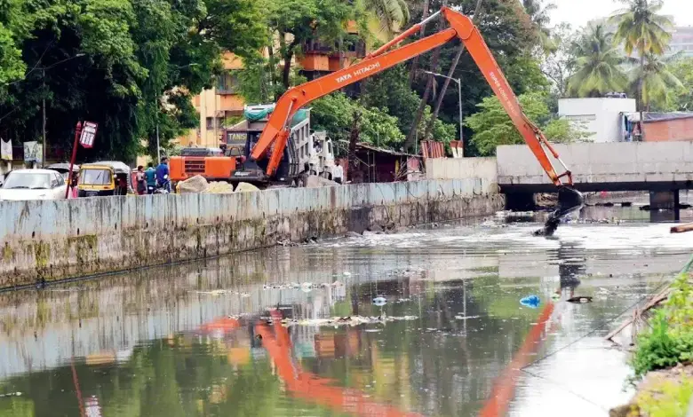 Workers cleaning a drain in Mumbai ahead of monsoon season